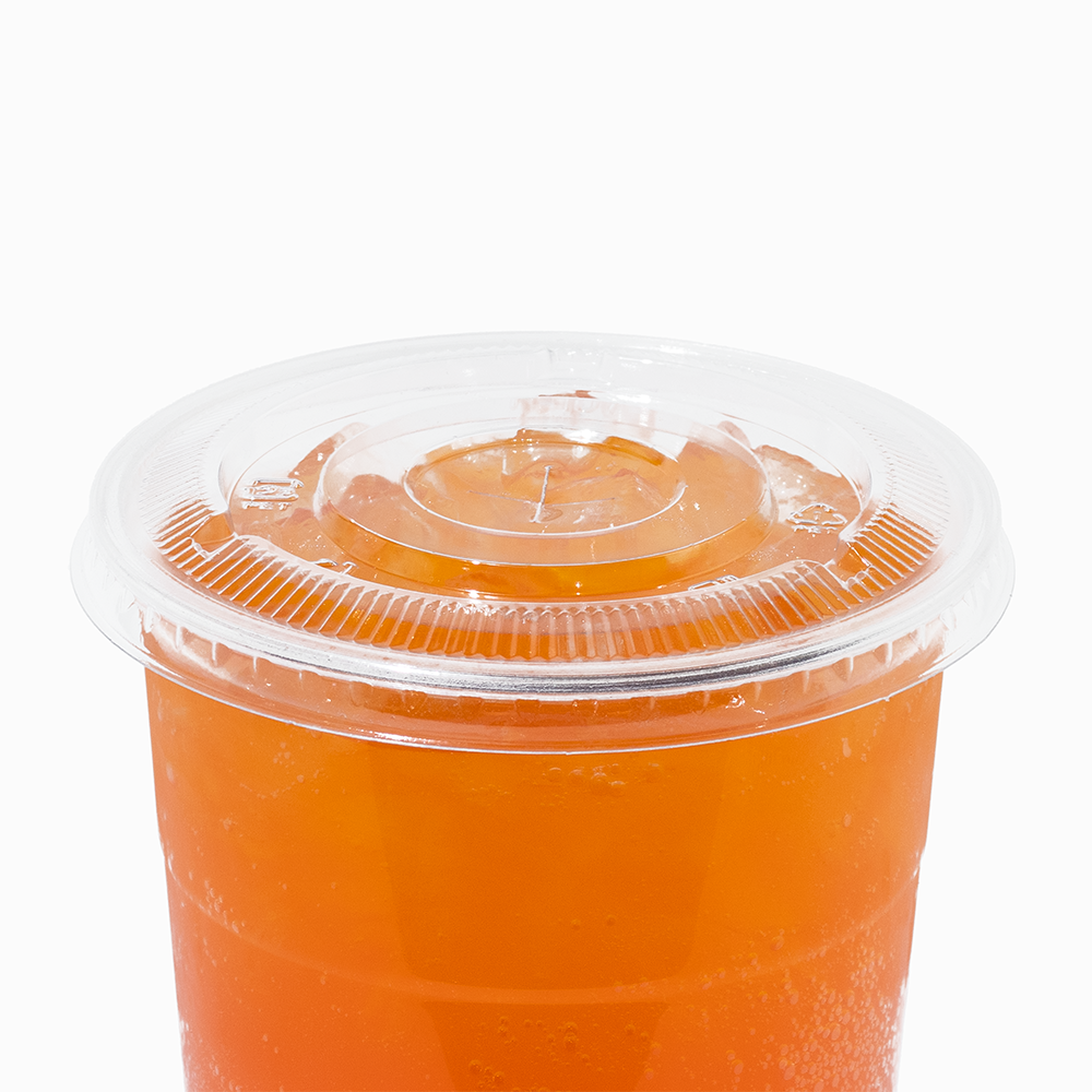 Clear 107mm flat lid on a 32 oz cold drink cup